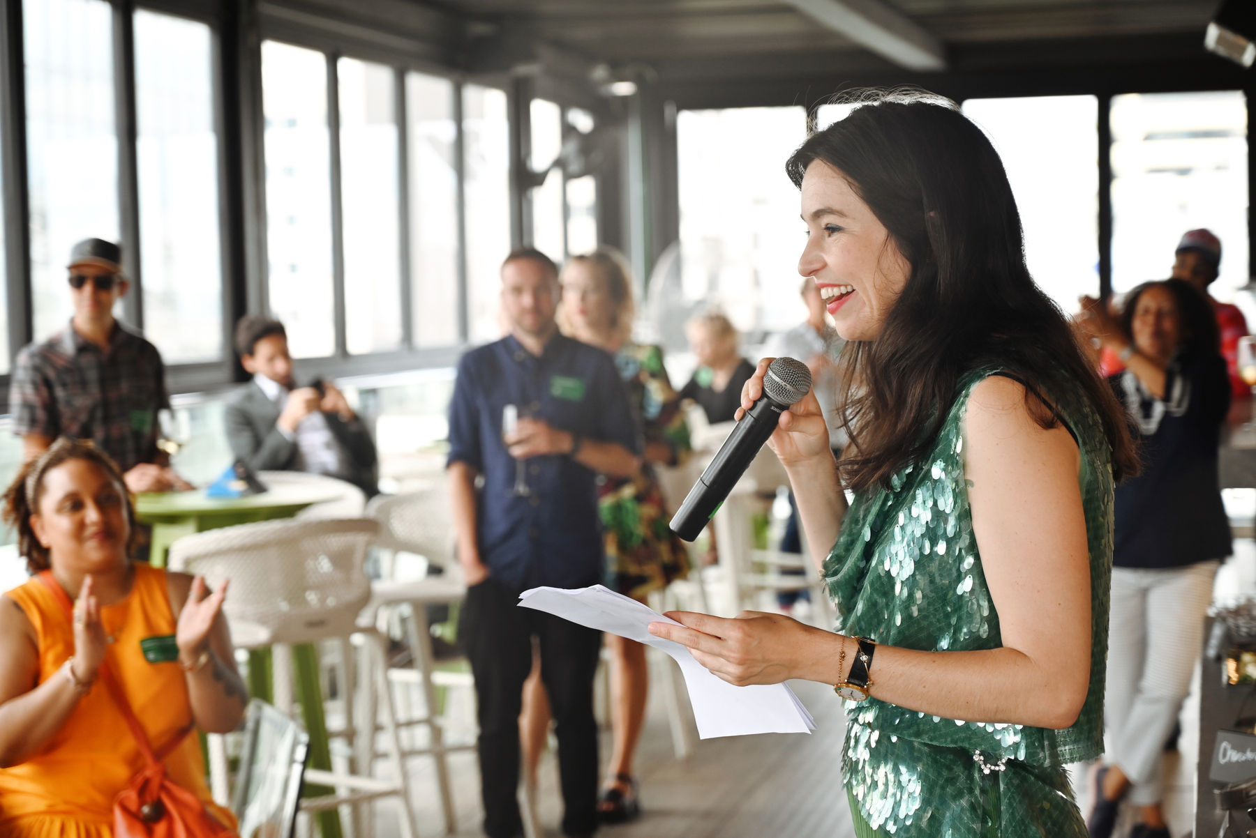Woman holding microphone and paper